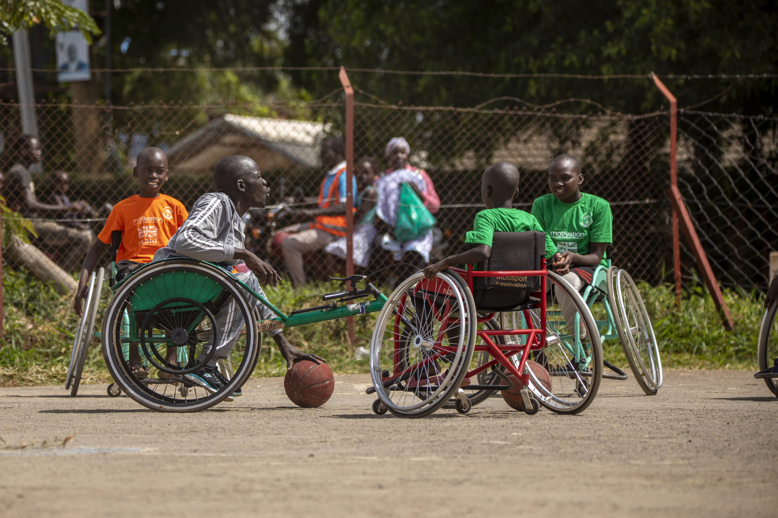 Coach Denis taking the students through warmup drills for wheelchair basketball during the sports event on 20.05.2022 in Gulu, Uganda.